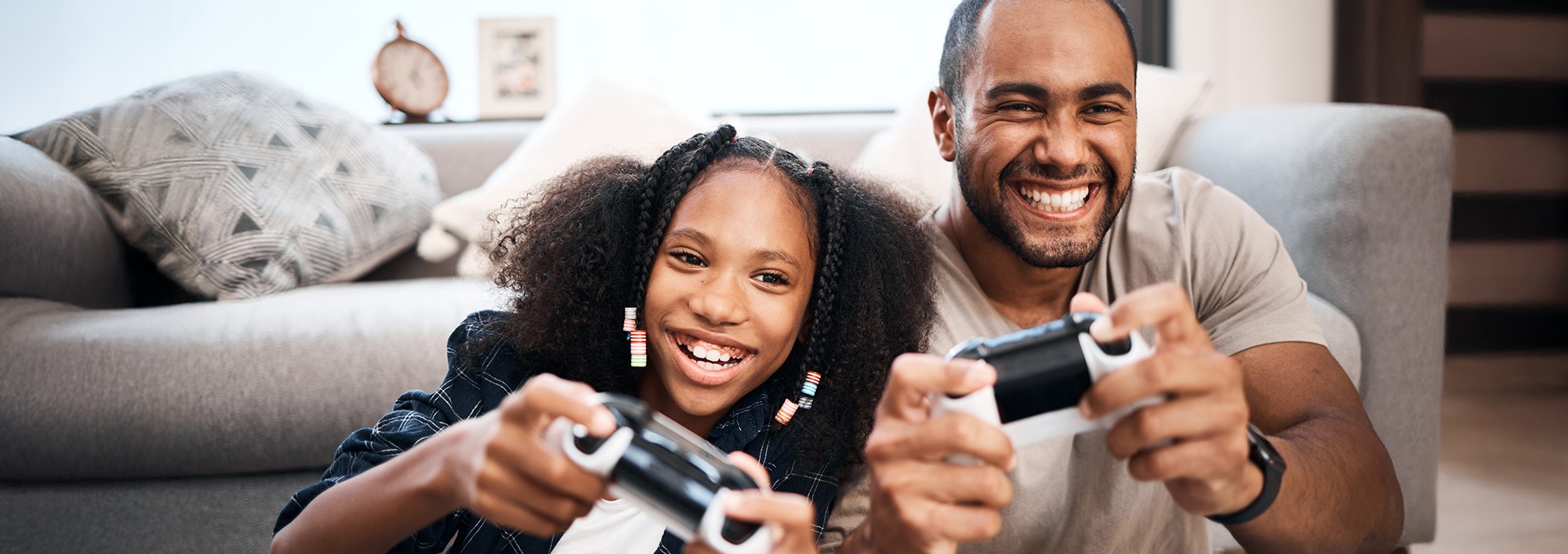Father and daughter playing videogame