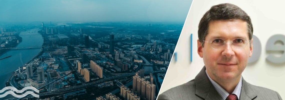 Split image of an aerial view of a city and a portrait of Bruno Lhopiteau