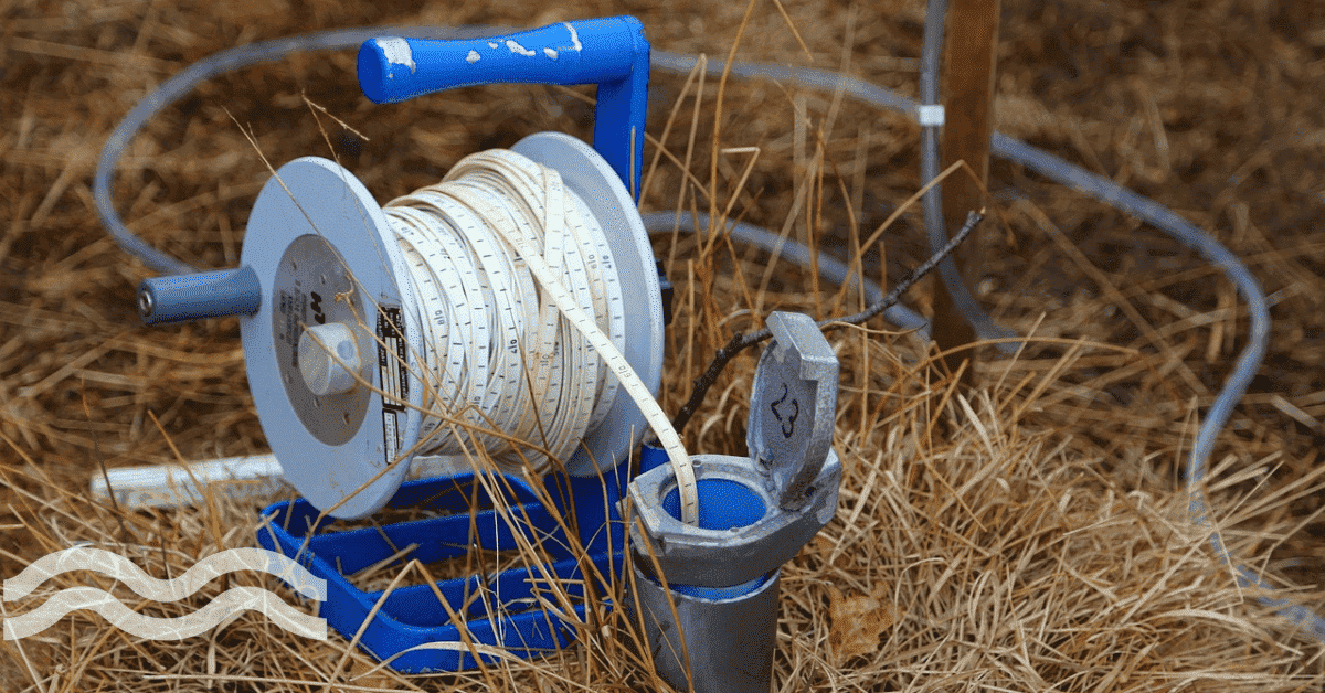 A spool carrying a wire that leads into a tube