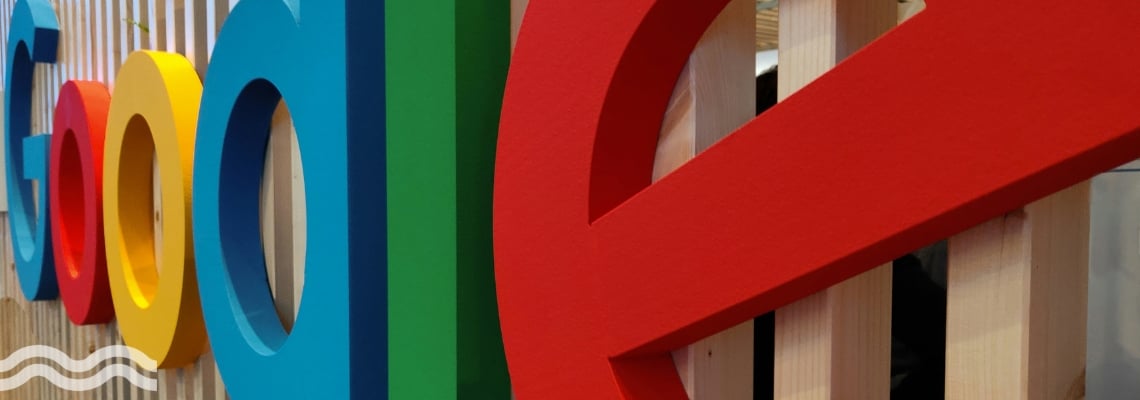 A close up of the Google logo on the side of an office building