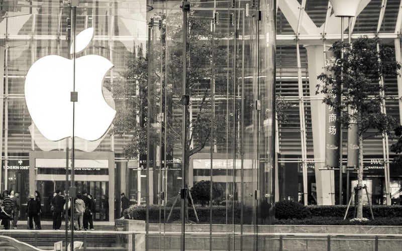Sepia image of a large Apple logo on the side of a glass wall