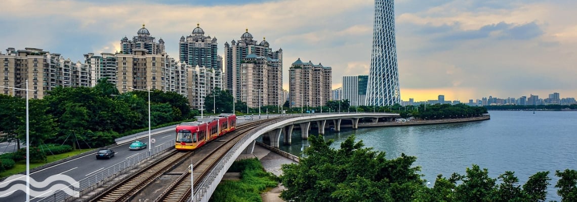 A picture of a river flowing past the financial centre of Guangzhou in China