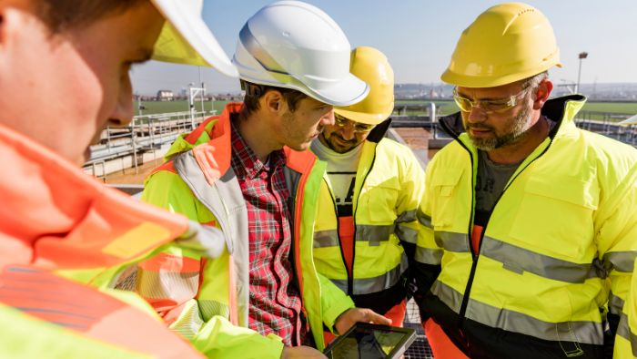 AQD--engineers-and-workers-assesing-wastewater-plant-700x394pc