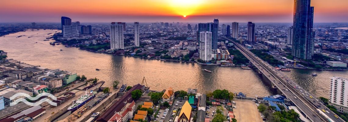 Bangkok with a bridge over a river linking suburban and industrial districts with the financial heart of the city