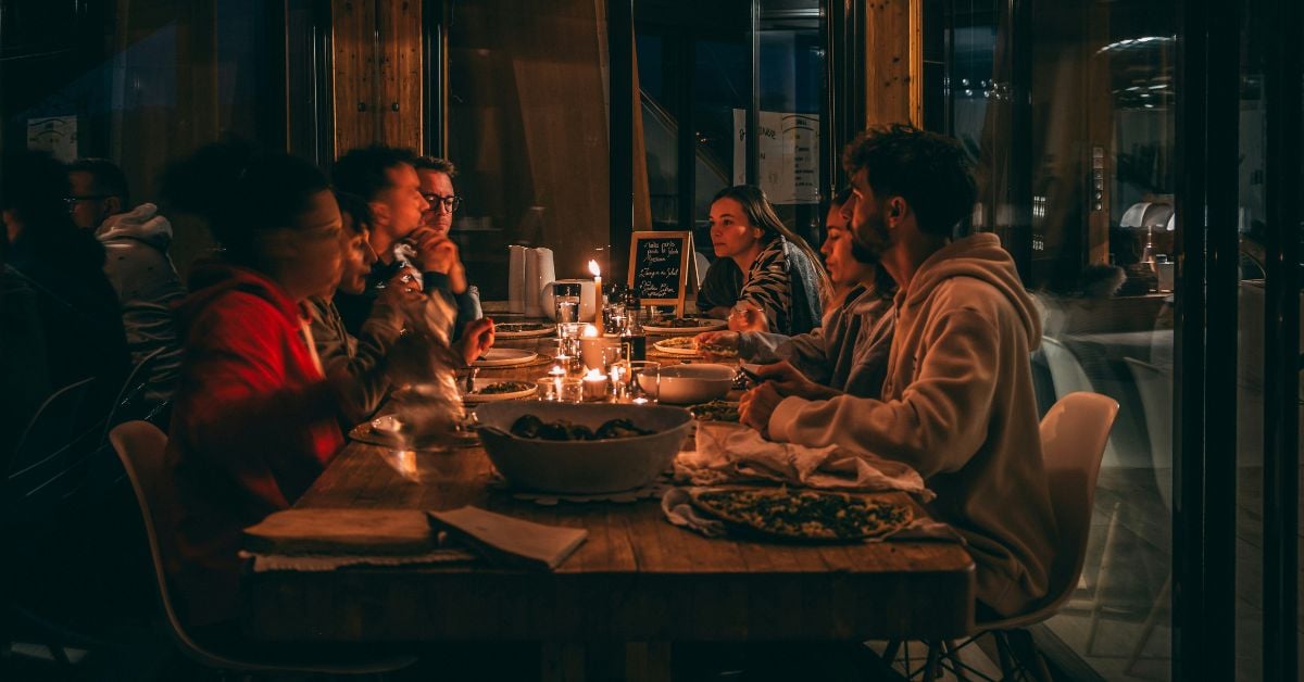 Gasten genieten samen van een diner in een sfeervol restaurant