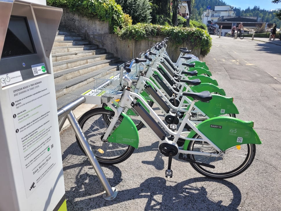 Green shared e-bikes docked at Lake Bled