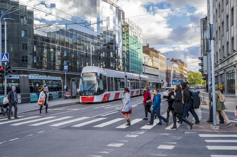 Tallinn tram passing through city centre with pedestrians crossing, illustrating free public transport for residents