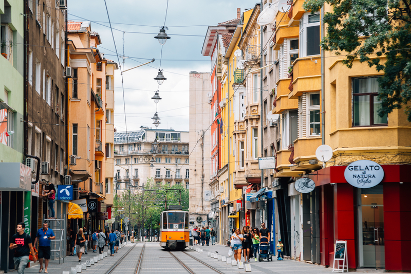 Tram running through a pedestrian street in Sofia, signalling on-demand and mode-switch incentives