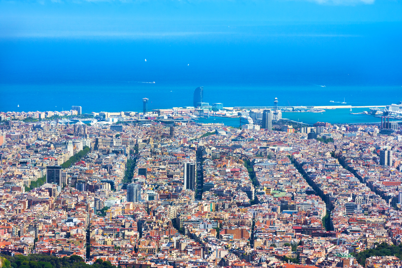 Aerial view of Barcelona’s city grid and waterfront, highlighting superblocks and modal shift goals