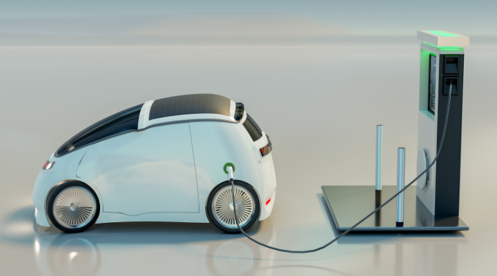 A small electric car charging at a modern charging station