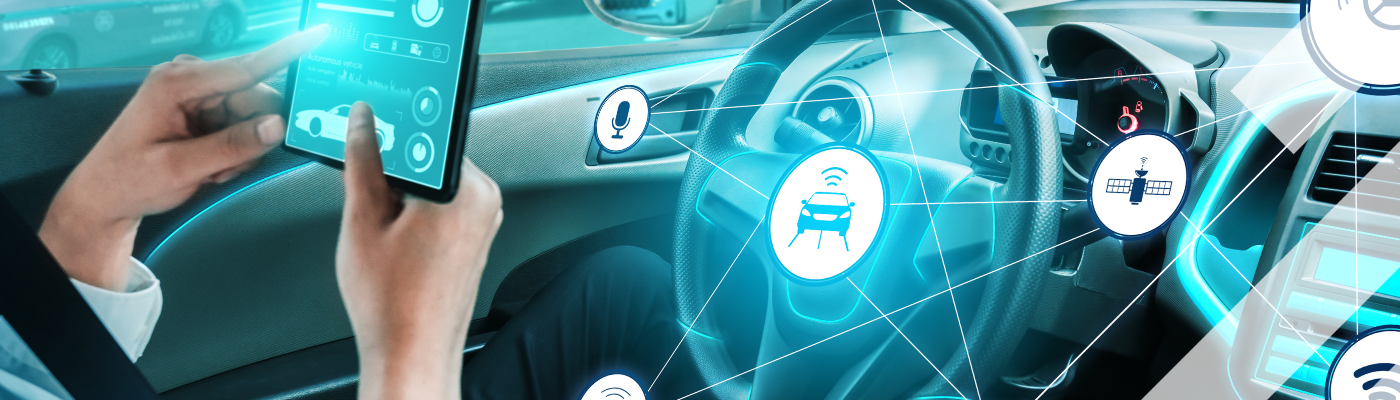 Person using a tablet to interact with a smart car's connected technology
