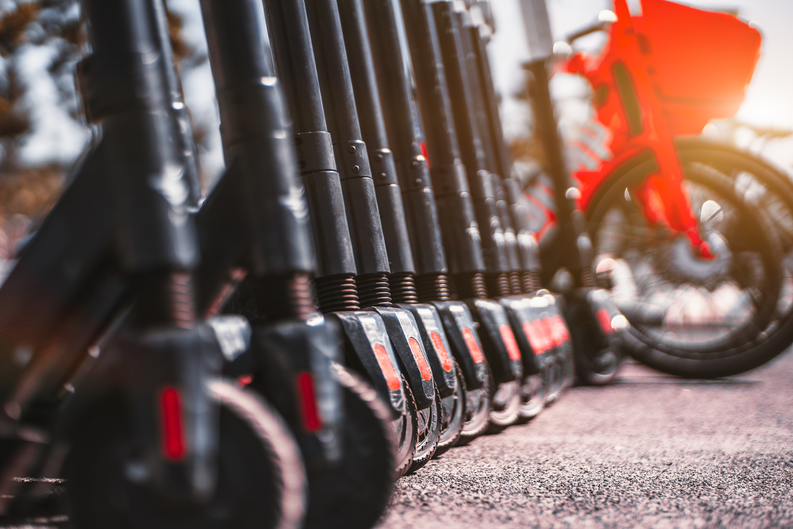 Close-up of a long row of shared e-scooters