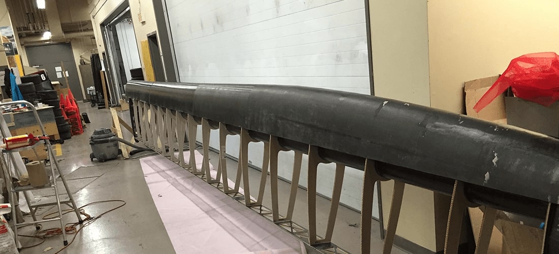 Close-up of a carbon-fibre component of the Rafale II catamaran, showcasing advanced composite engineering designed to improve performance and reduce weight.