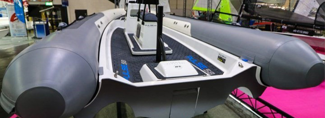 Electric boat on display at an indoor exhibition.