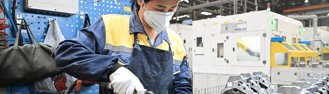 A chinese mechanic remanufacturing a car part