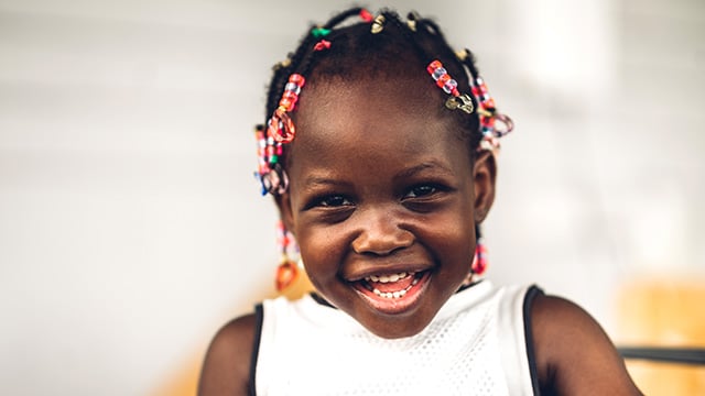 A young girl smiling