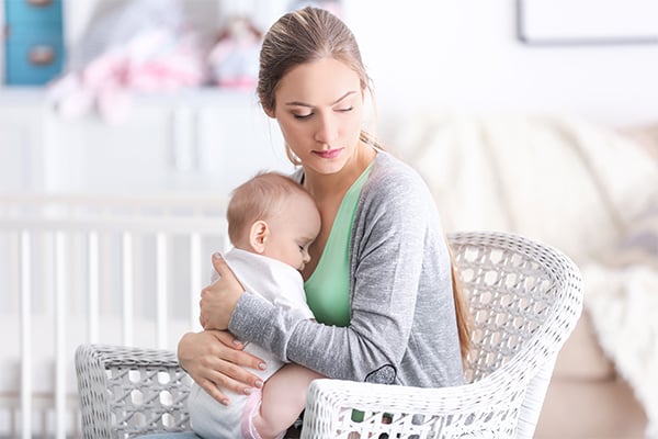 A young woman with a baby at home