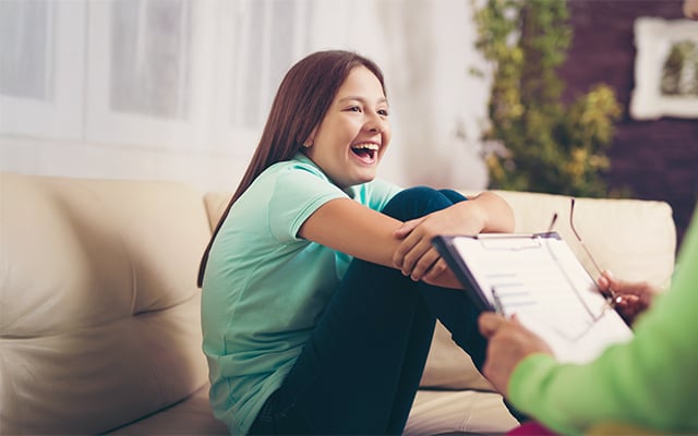 Teenage girl smiling during a therapy session
