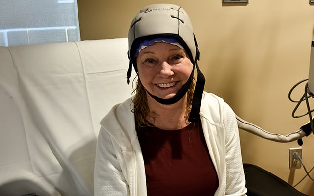 A patient using the Paxman Scalp Cooling System at Reid Health