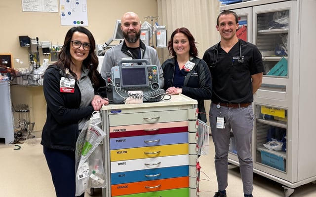Members of the Reid Health Pediatric Readiness care team posing with a medical cart designated for pediatric care in the emergency room