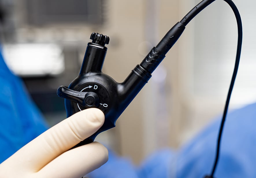 A medical provider holding a piece of surgical equipment