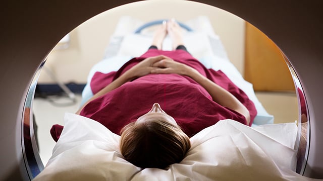 A woman patient undergoing computed tomography (CT) scan