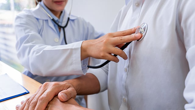 A doctor examining the patient by using stethoscope 