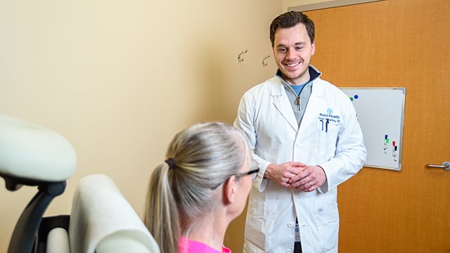 Vascular Surgeon, Dr. Sean Malarkey smiling at a patient