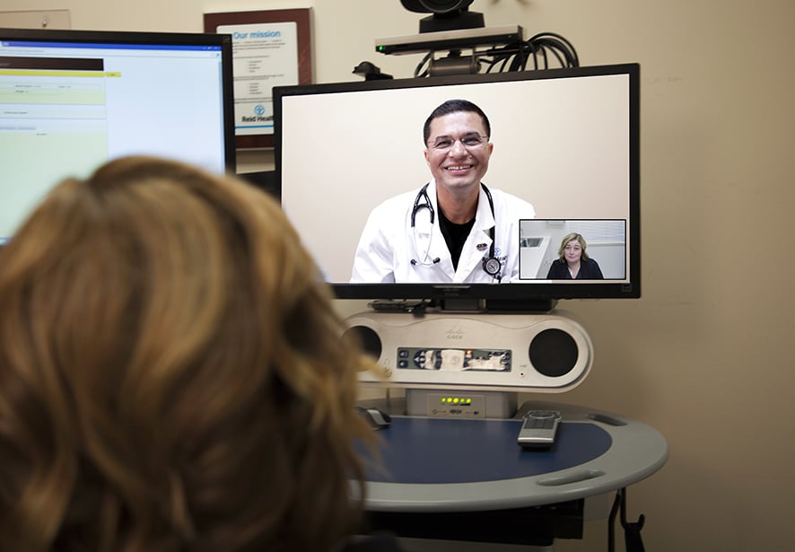 Reid Health Cardiologist, Rubinder Dab, MD having a telehealth appointment with a patient