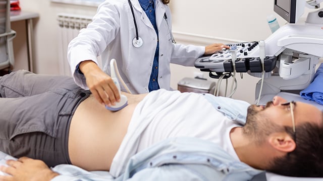 A man laying on his back having a vascular ultrasound done