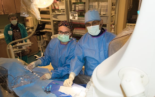 Members of the Reid Health Heart and Vascular team in the cath lab performing a procedure.