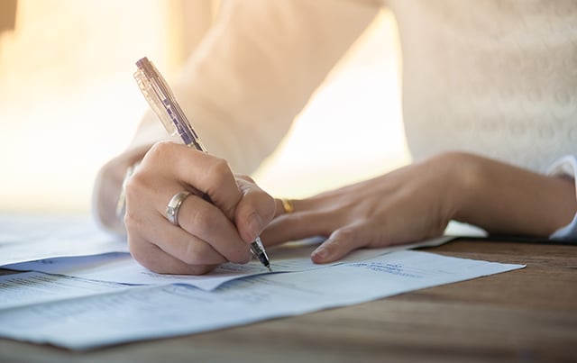 A woman filling out paper work