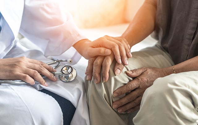A doctor comforting a patient