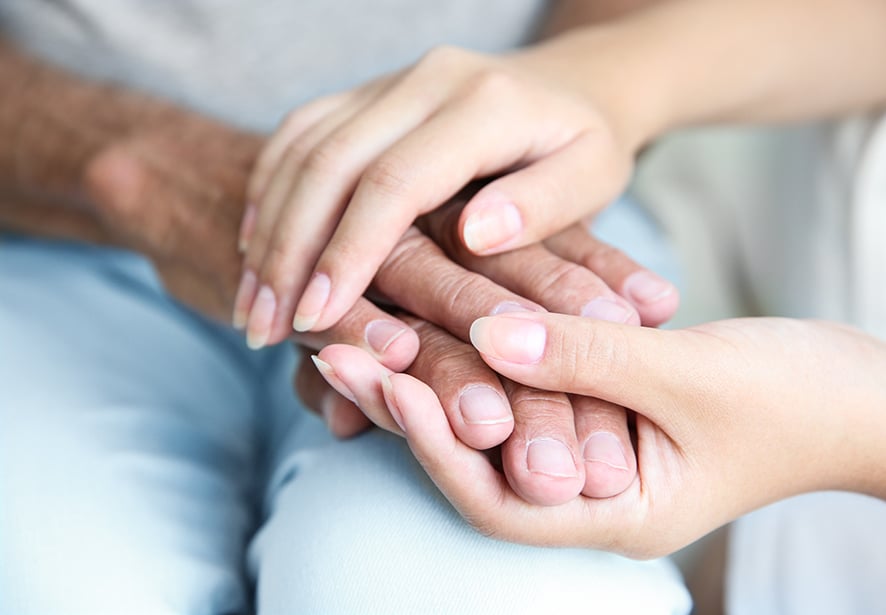 One person embracing another person hands