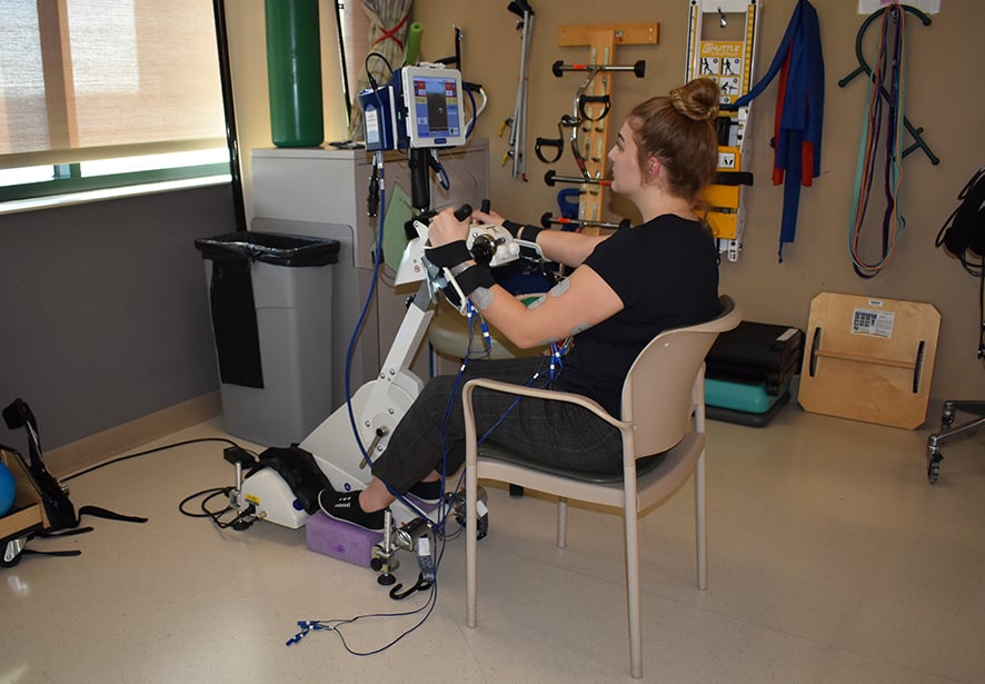A patient in the acute rehab unit using the e-stim bike