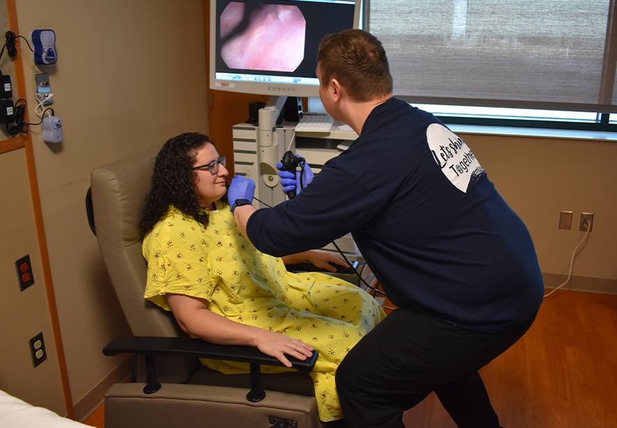 A Reid health team member performing a Fiberoptic Endoscopic Evaluations of Swallowing (FEES) study on a patient