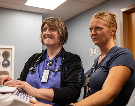 Two Reid Health nurses working at a work station together