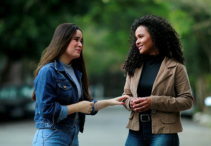 Two women walking in the street talking