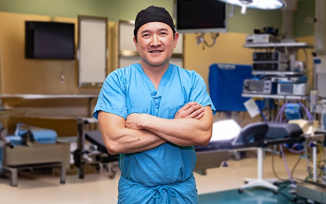 Reid Health spine surgeon, Dr. Hon Vien standing in front of an operating table