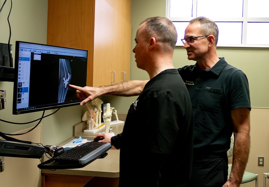 Reid Health Orthopedics' Chris Neher, MD and Chris Pruitt, PA consulting together