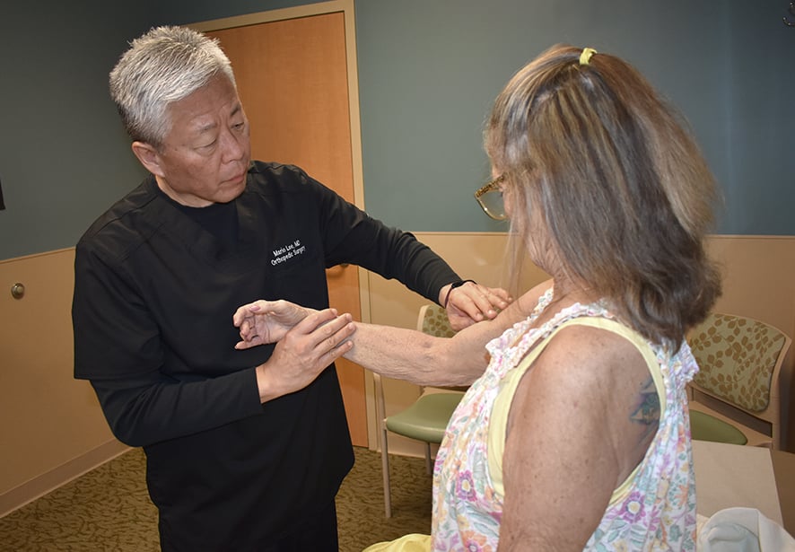 Reid Health's Mario Lee, MD examining a patient