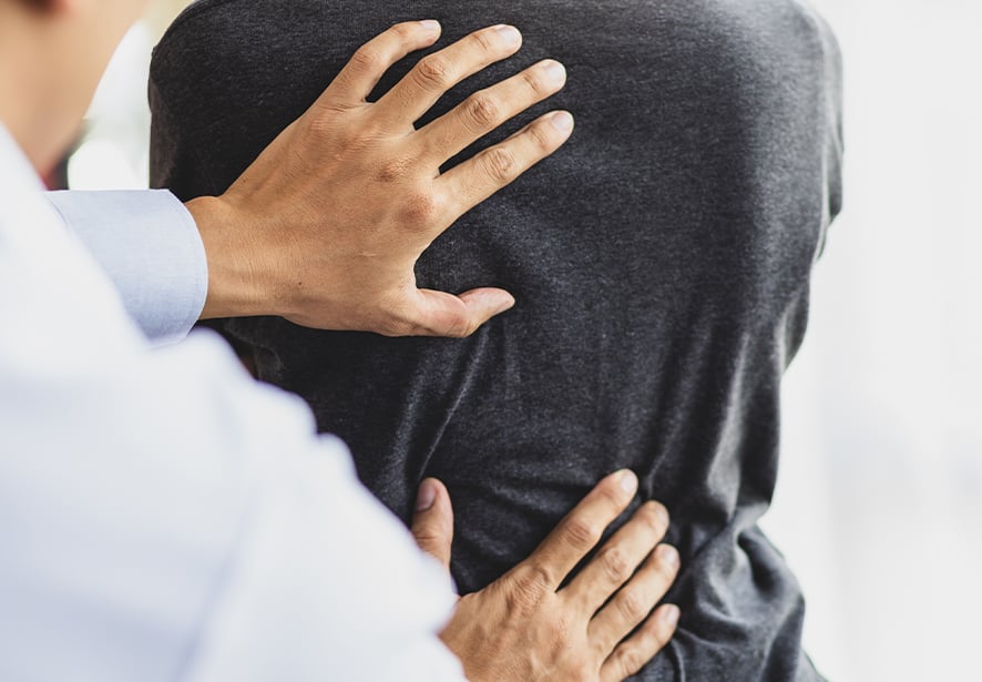 A pain management doctor examining a patient