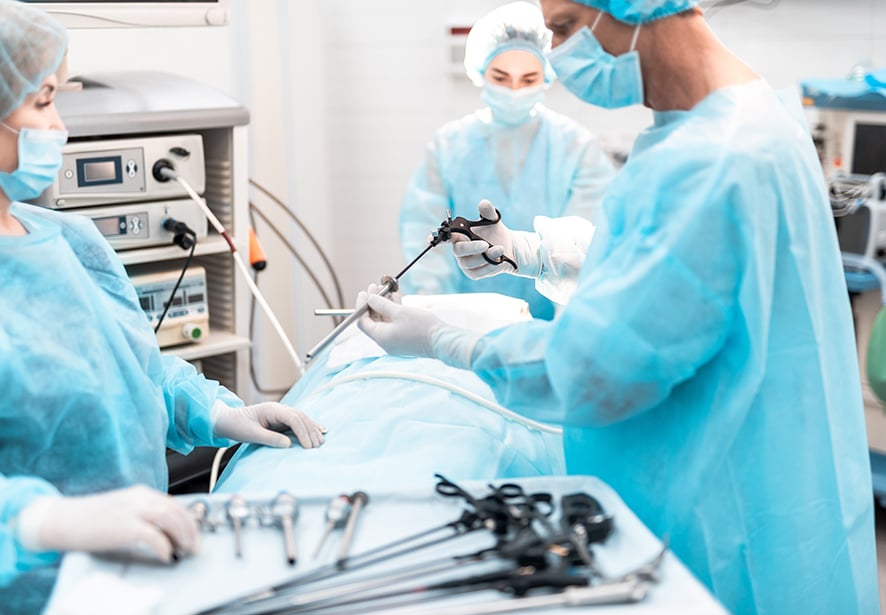A team of surgeons working together in an operating room with equipment