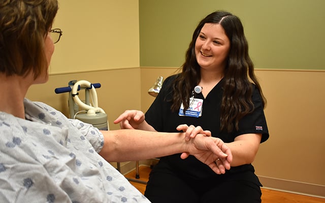 Reid Health's Ariel Zeiler PA-C, examining a patient 