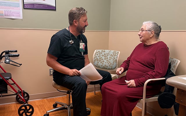 Reid Health's Jay Hartman, PA speaking with a patient