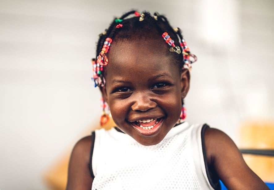 A young African American girl smiling 