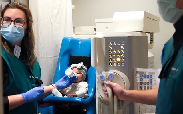 Reid Health employees preforming a swallow study on an infant