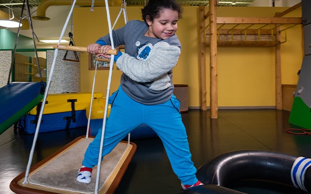 A child participating in therapy session at Reid Pediatric Rehabilitation Services