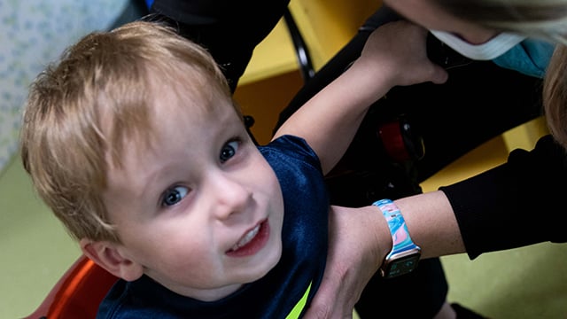 A young boy looking up and smiling