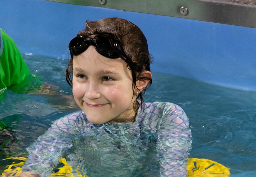 A young girl participating in aquatic therapy 